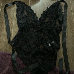 Black see through body suit.